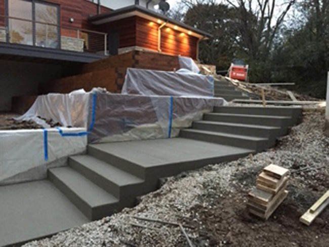 Concrete stairs are being built in front of a house
