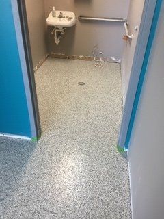 A bathroom with a sink and a walk in shower.