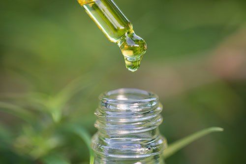 Droplet hemp oil into a glass bottle, CBD Hemp oil