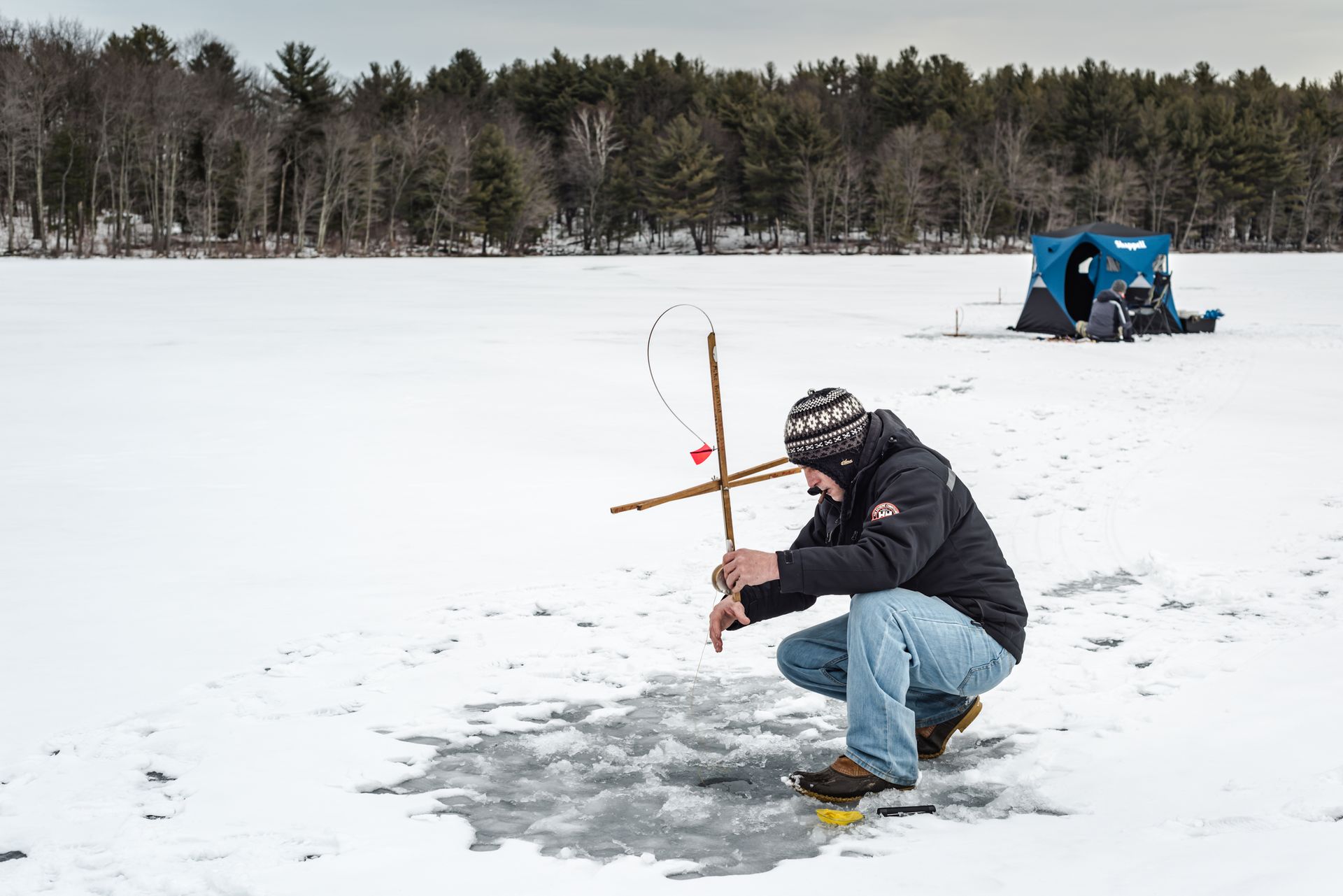 Ice fishing on frozen Mill Pond at Grafton State Park in Upstate New York, Rensselaer County