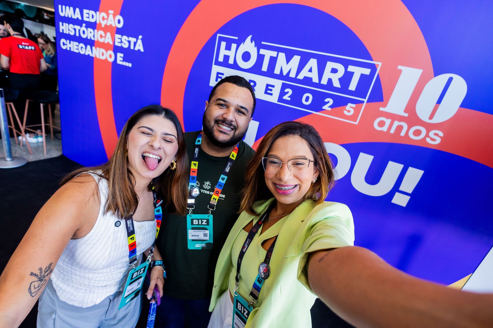 Um grande grupo de pessoas está posando para uma foto em um estacionamento.