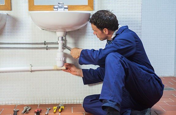 Plumbing Service — Man Repairing Sink in Las Vegas, NV