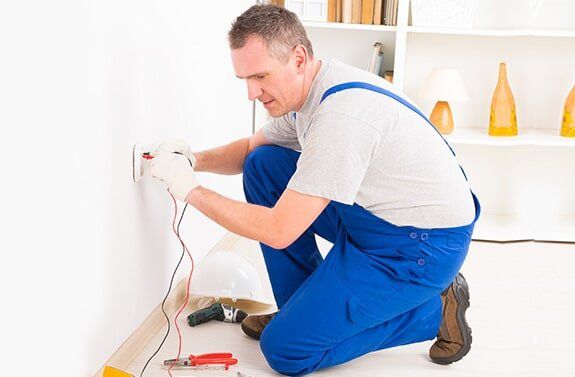 Electric Services — Man Repairing Outlet in Las Vegas, NV