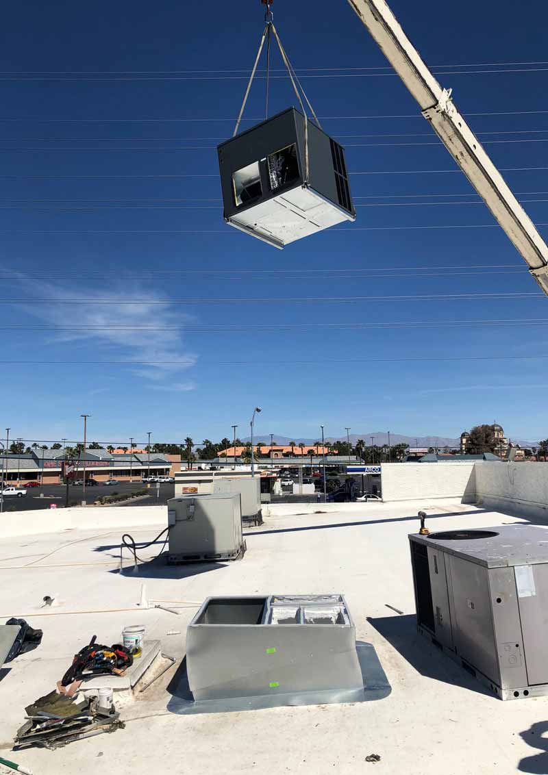 Air Conditioner — Air Conditioner Hooked on Crane in Las Vegas, NV
