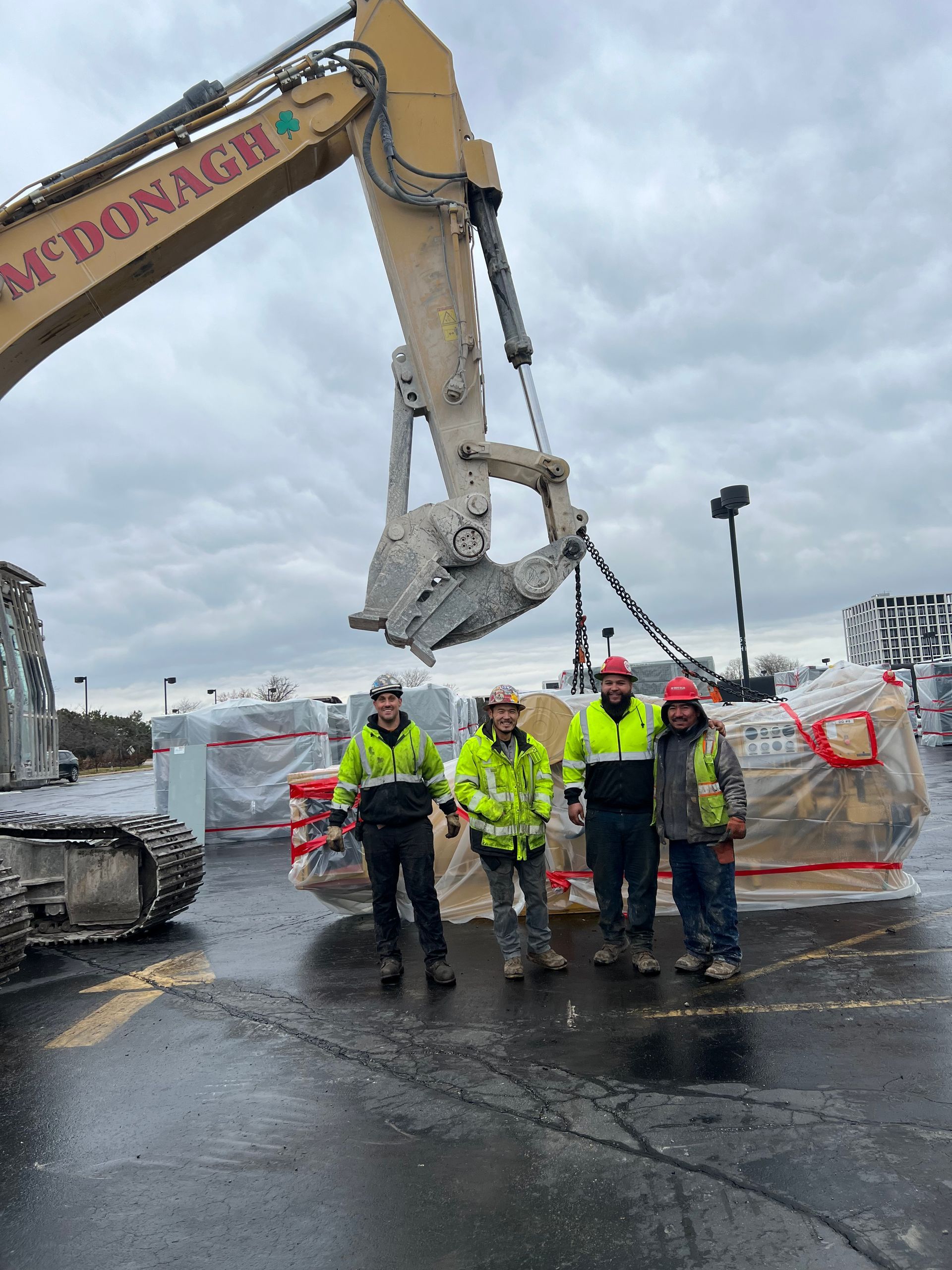 A group of men standing in front of a mcdonald 's excavator