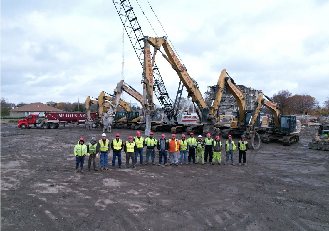 A group of construction workers are posing for a picture