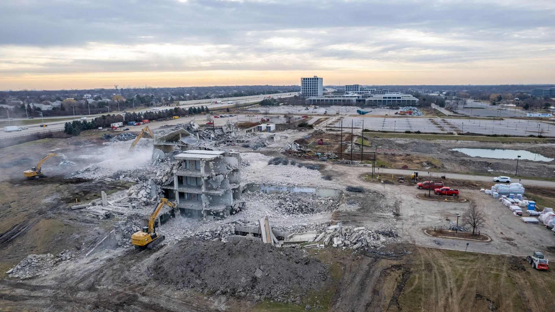 An aerial view of a large building being demolished.