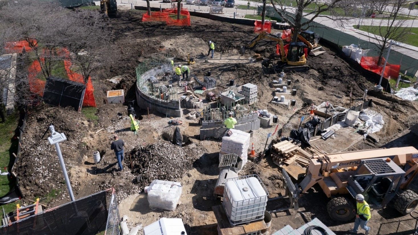 An aerial view of a construction site with workers and machinery.