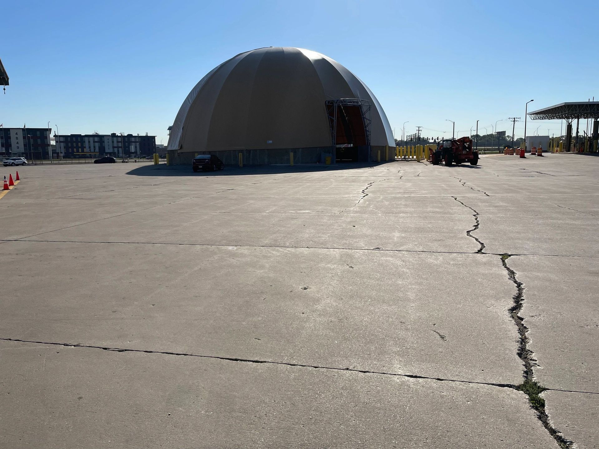 A large dome is in the middle of a parking lot