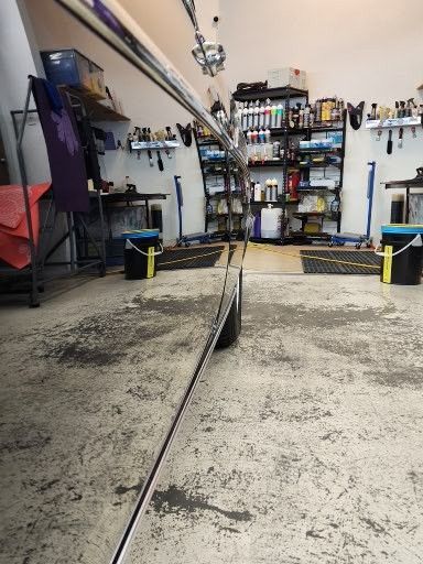 A garage with a reflection of a car in the mirror