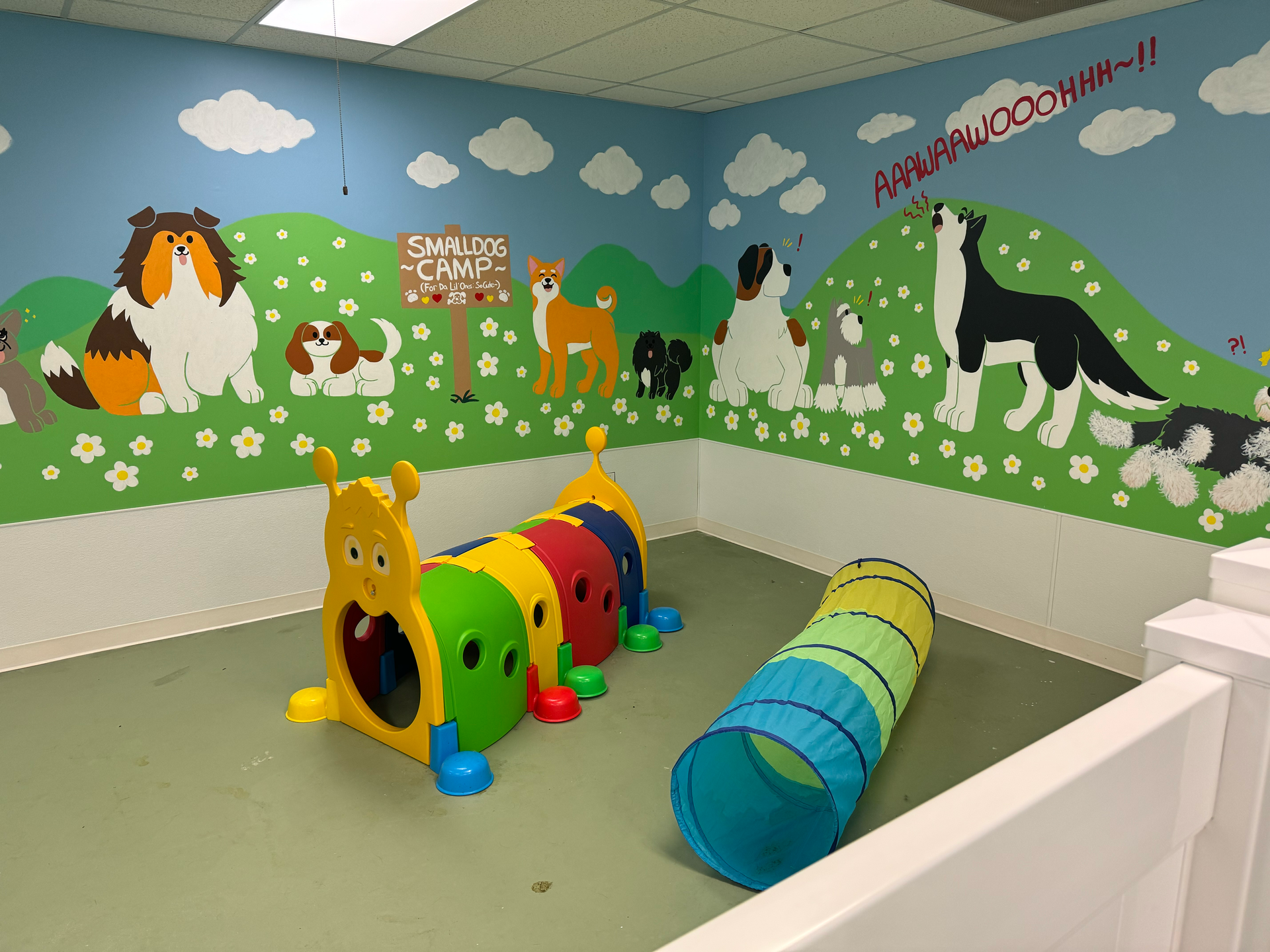 A room with a tunnel and a painting of dogs on the wall.