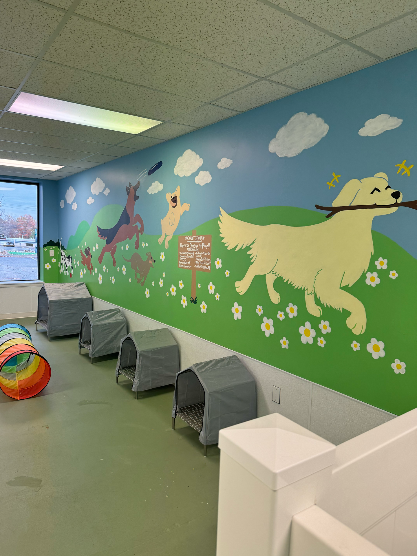 A room with a painting of a dog on the wall