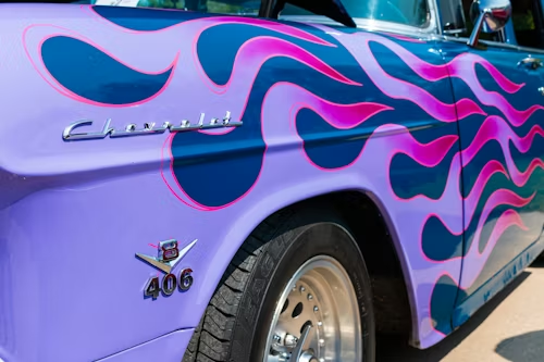 Purple Chevrolet car with flame design.