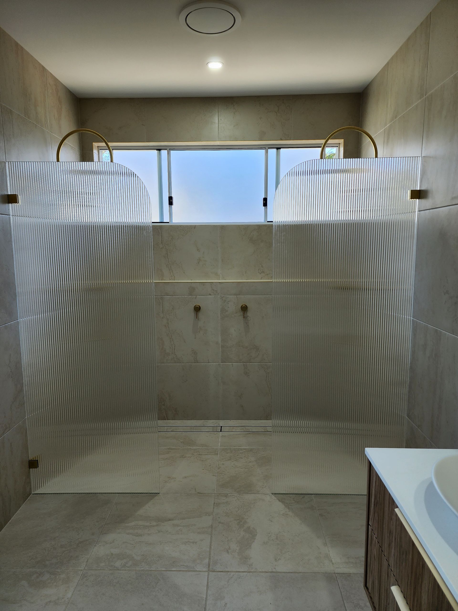 A Bathroom With A Sink And A Walk In Shower — Lumba Glass & Glazing In Kincumber, NSW 