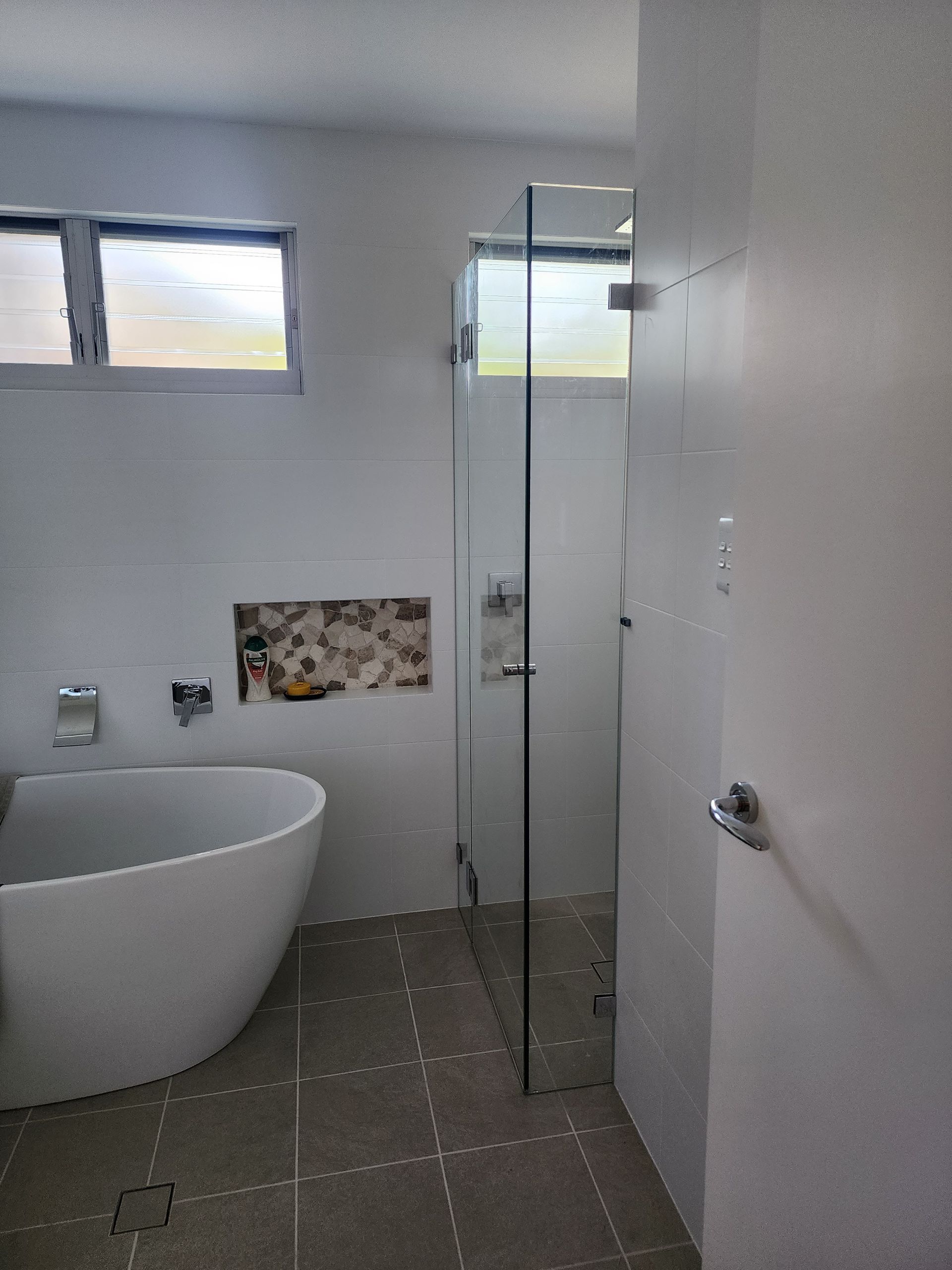 A Bathroom With A Shower, Sink And Mirror — Lumba Glass & Glazing In Kincumber, NSW