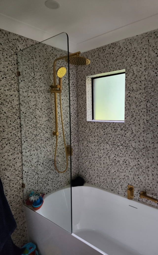 A Bathroom With A Bathtub, Shower, And Window — Lumba Glass & Glazing In Kincumber, NSW 