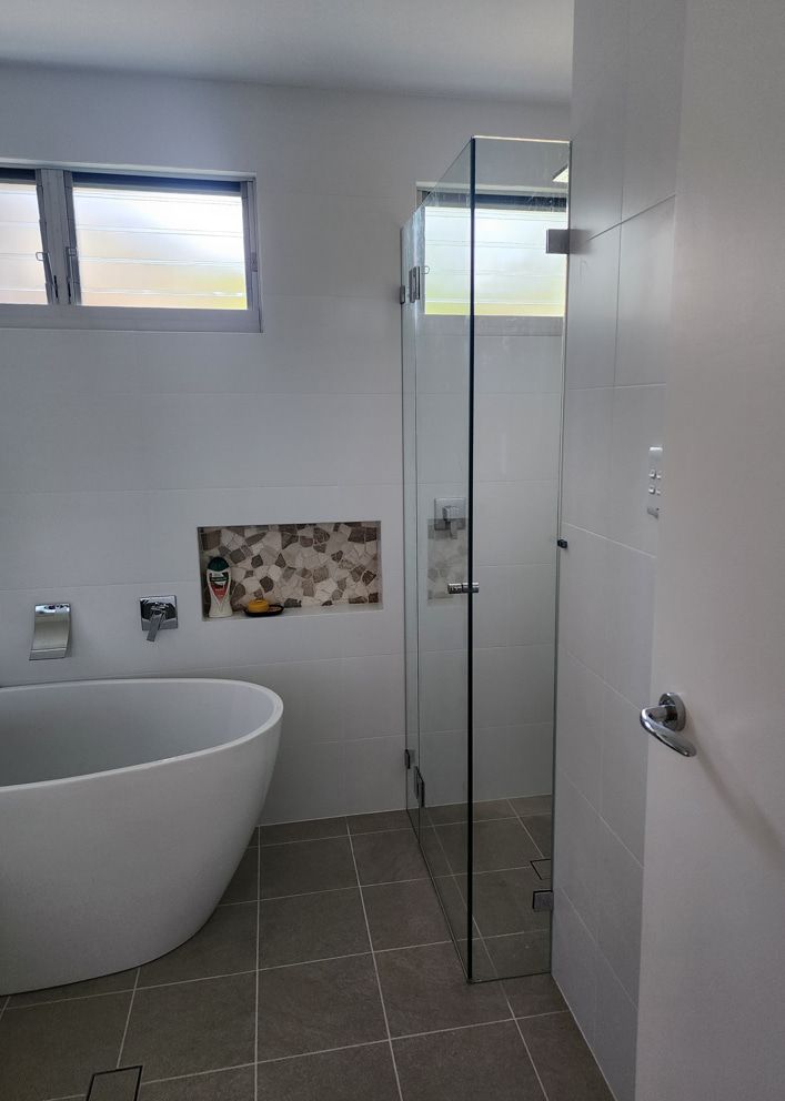 A Bathroom With A Bathtub And A Walk In Shower — Lumba Glass & Glazing In Kincumber, NSW