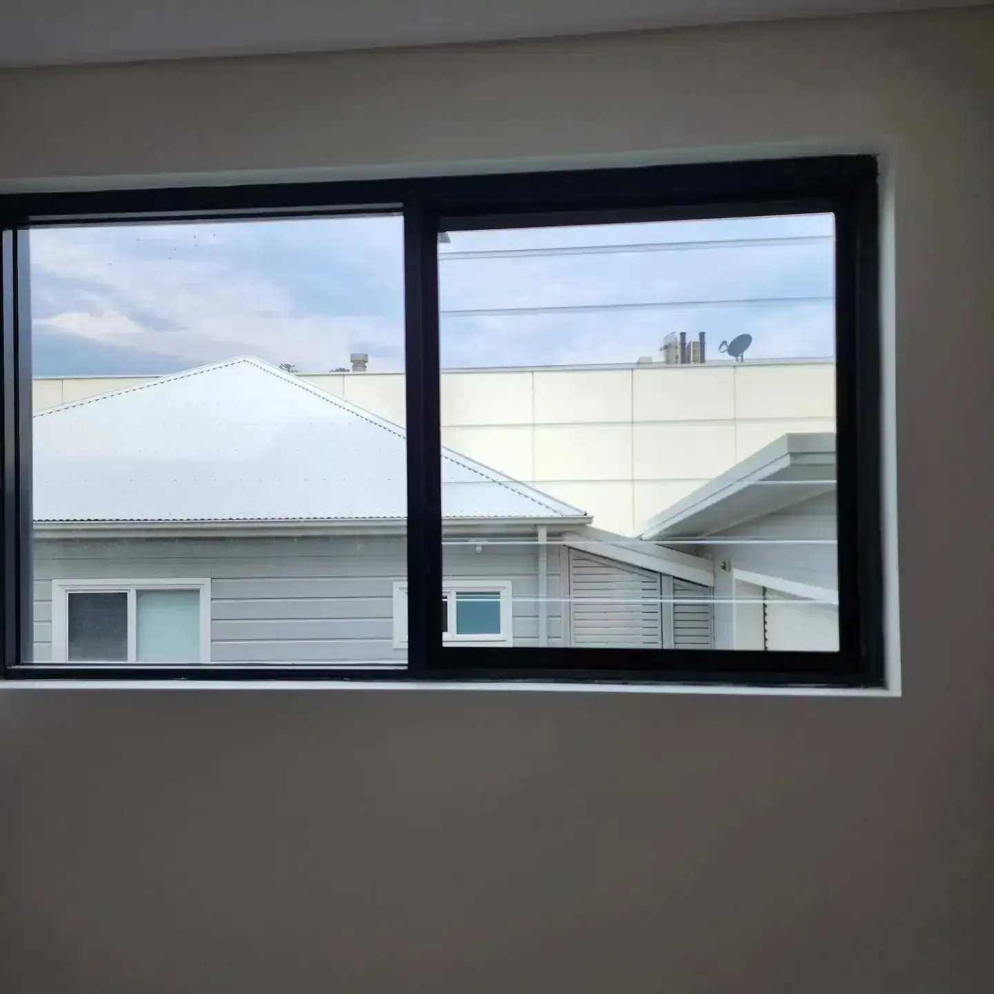 A Window In A Room With A View Of A House — Lumba Glass & Glazing In Kincumber, NSW