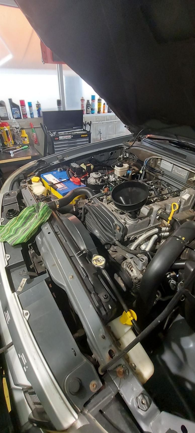 The Hood of A Car Is Open and The Engine Is Visible — Coastal Mechanical Servicing and Repairs in Wurtulla, QLD