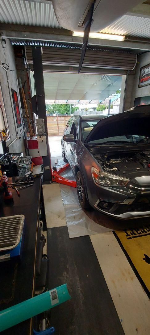 A Car Is Parked in A Garage with The Hood Up — Coastal Mechanical Servicing and Repairs in Wurtulla, QLD
