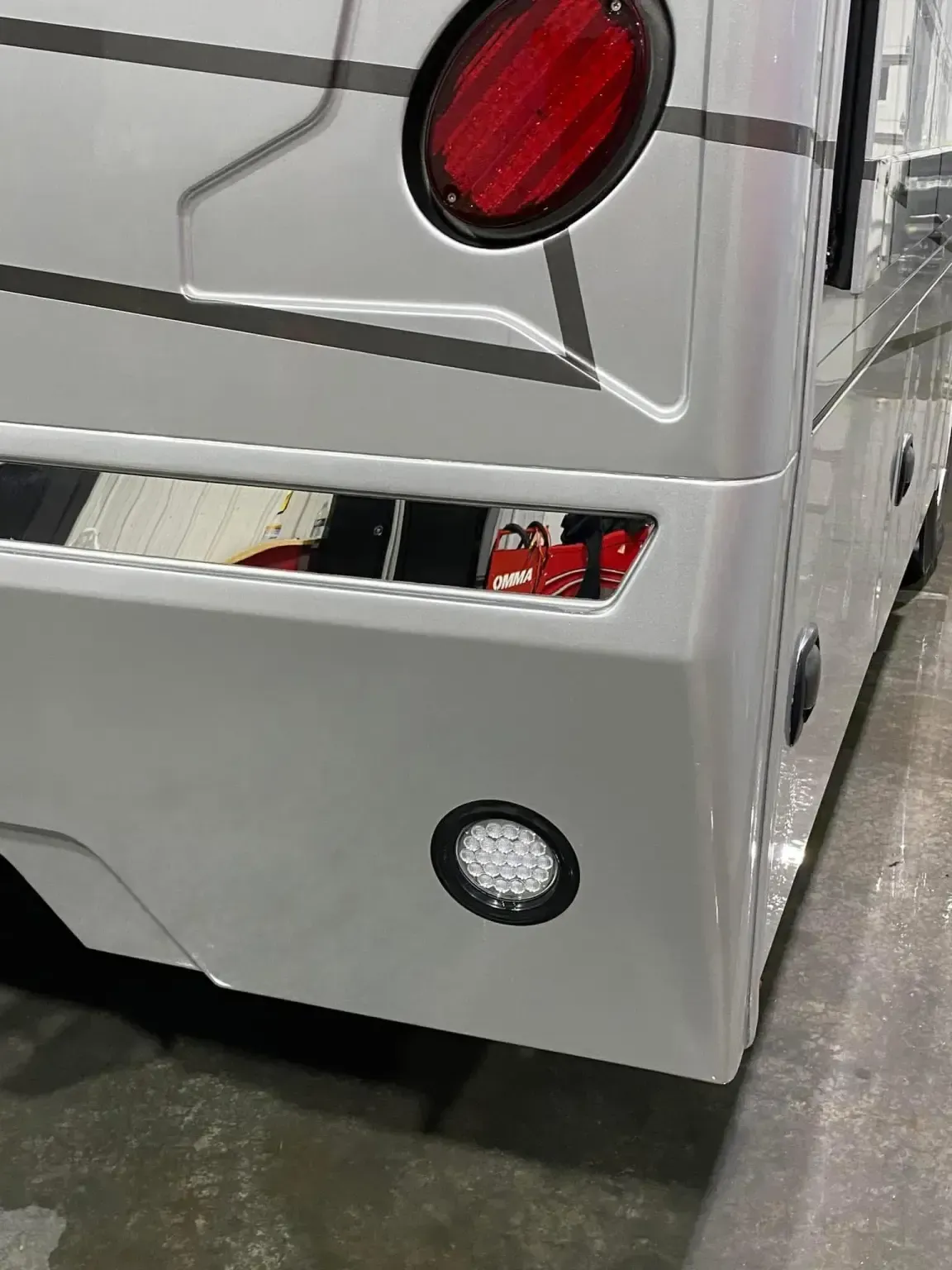 Orange Ram truck with black accents, parked indoors.