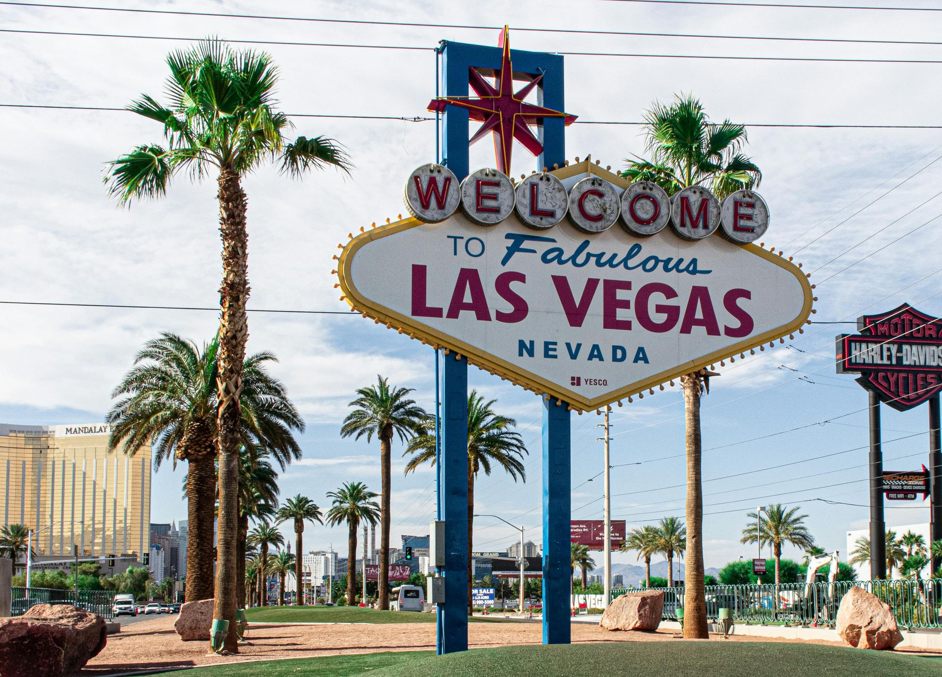 Welcome to Fabulous Las Vegas sign with palm trees and a clear blue sky