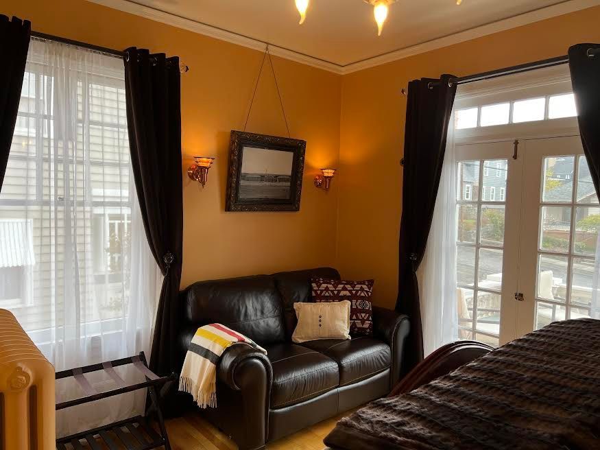 A living room with a couch and a bed in it