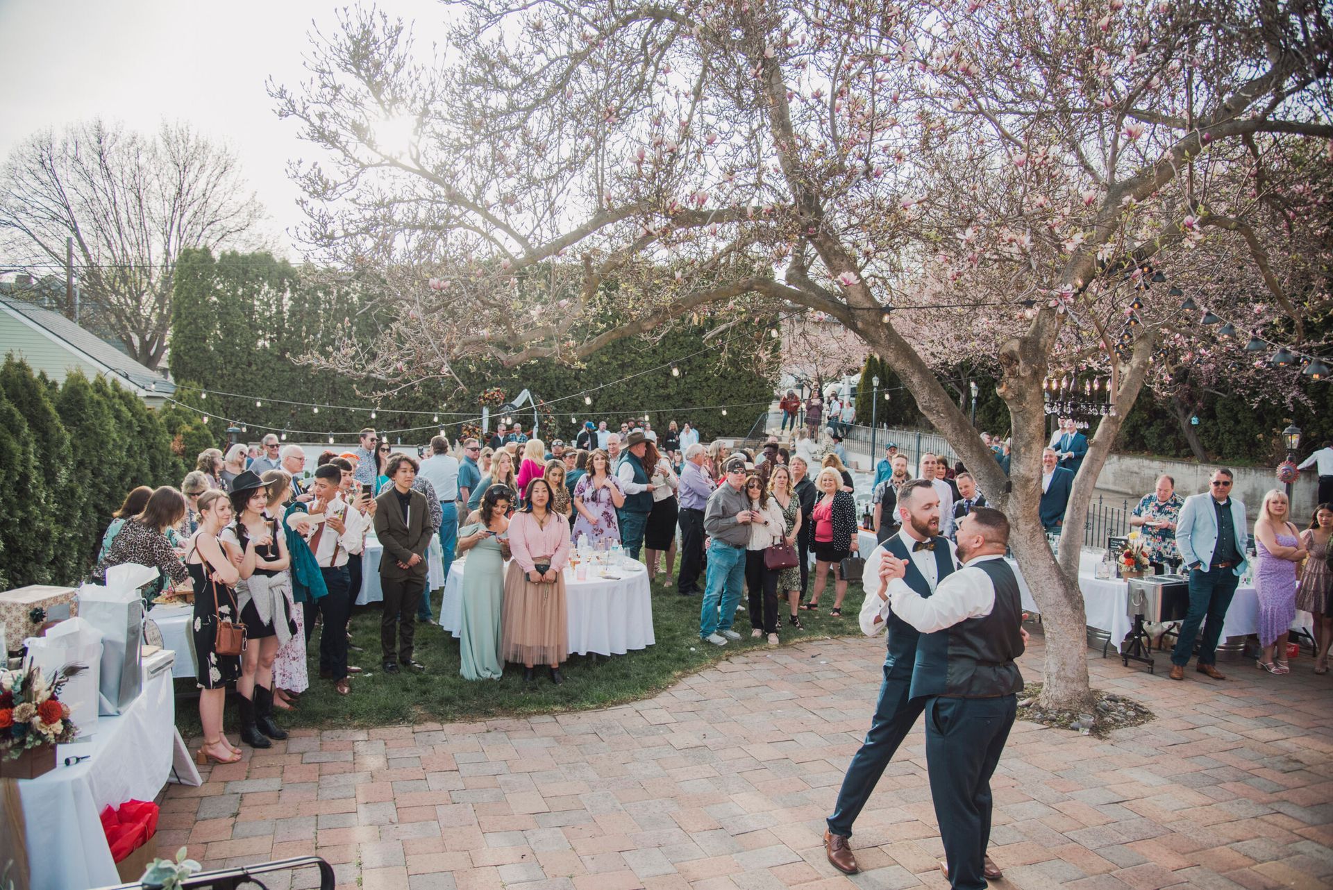 A couple is dancing in front of a crowd of people at a wedding reception.