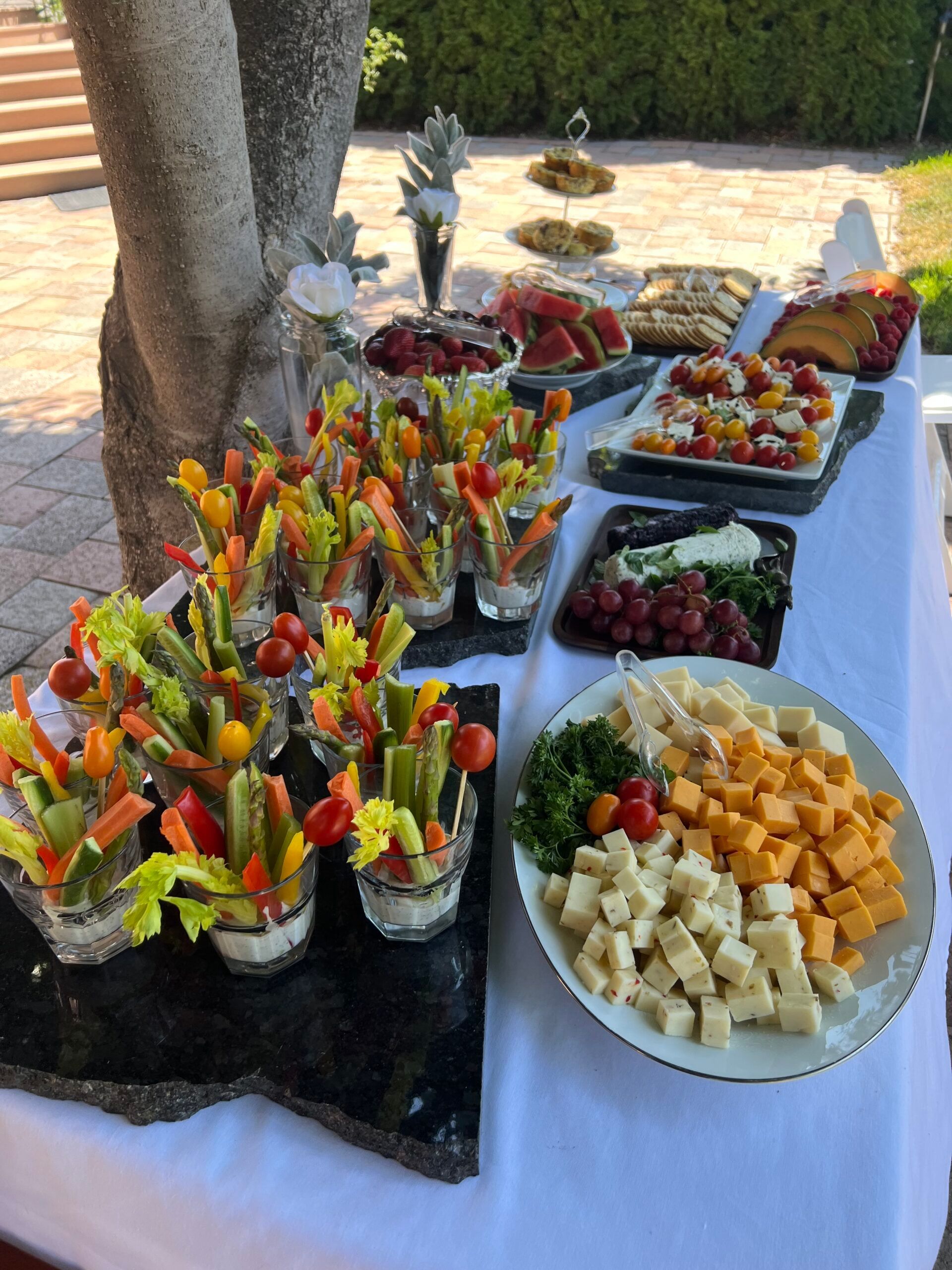 A table topped with a variety of food including vegetables and cheese.