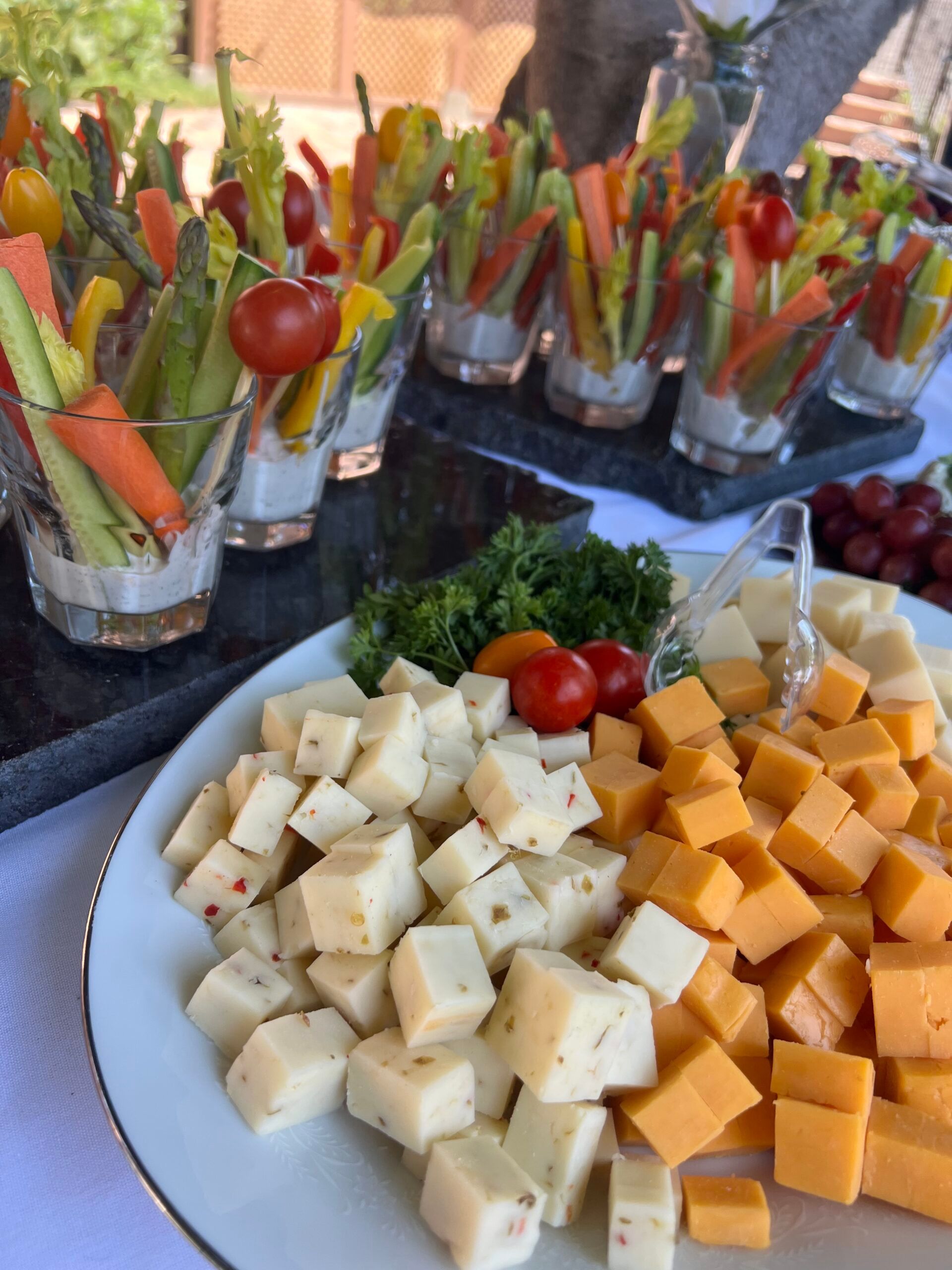 A plate of cheese and vegetables on a table