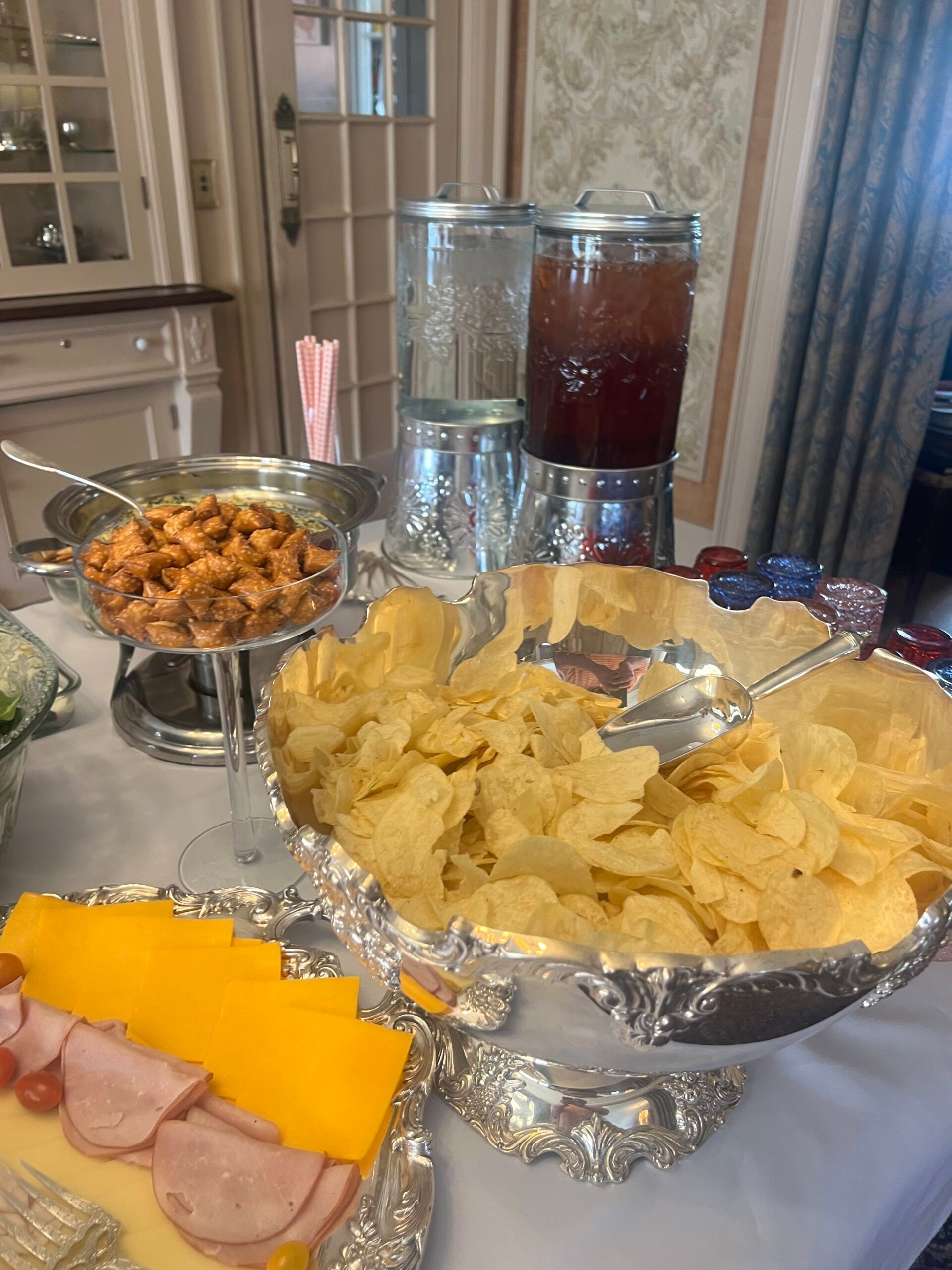 A buffet table with a bowl of chips and a bowl of shrimp.