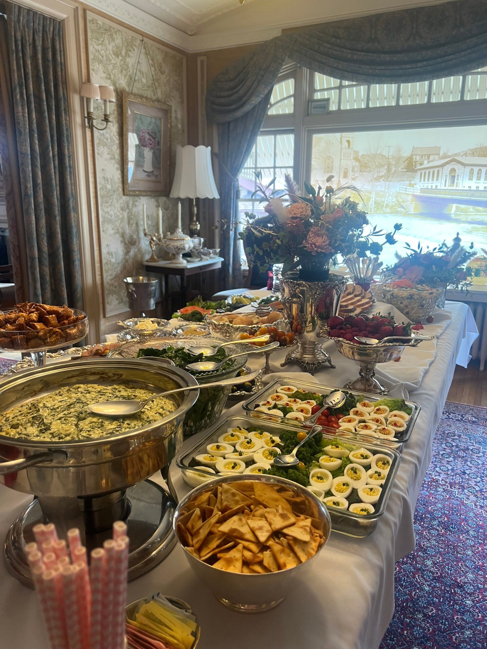 A buffet table filled with lots of food in a room.