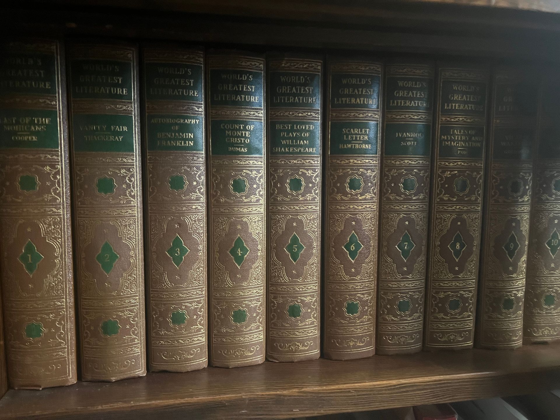 A row of books on a shelf with one titled ' a brief history of the world '
