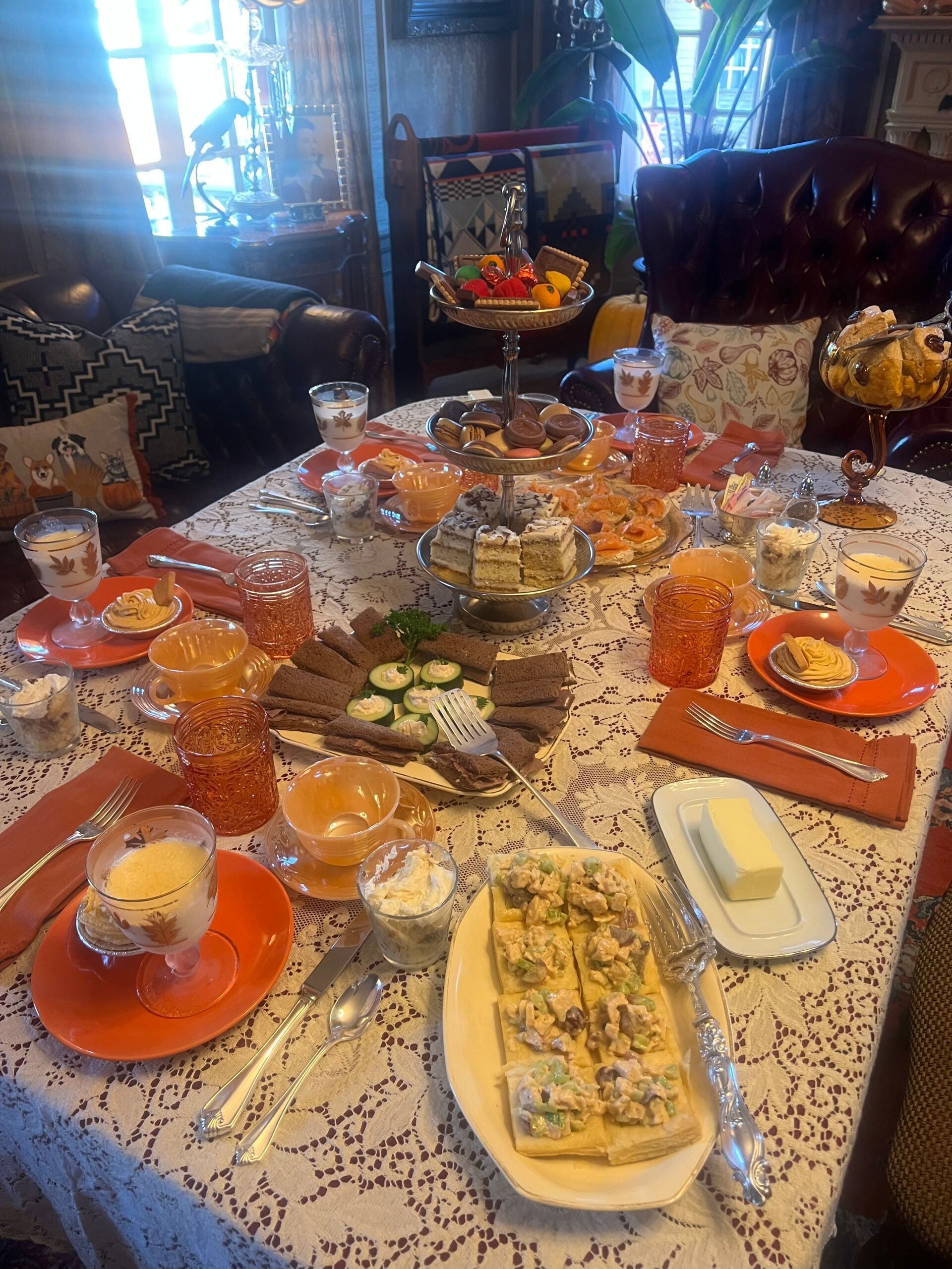 A table topped with plates of food and glasses of wine.