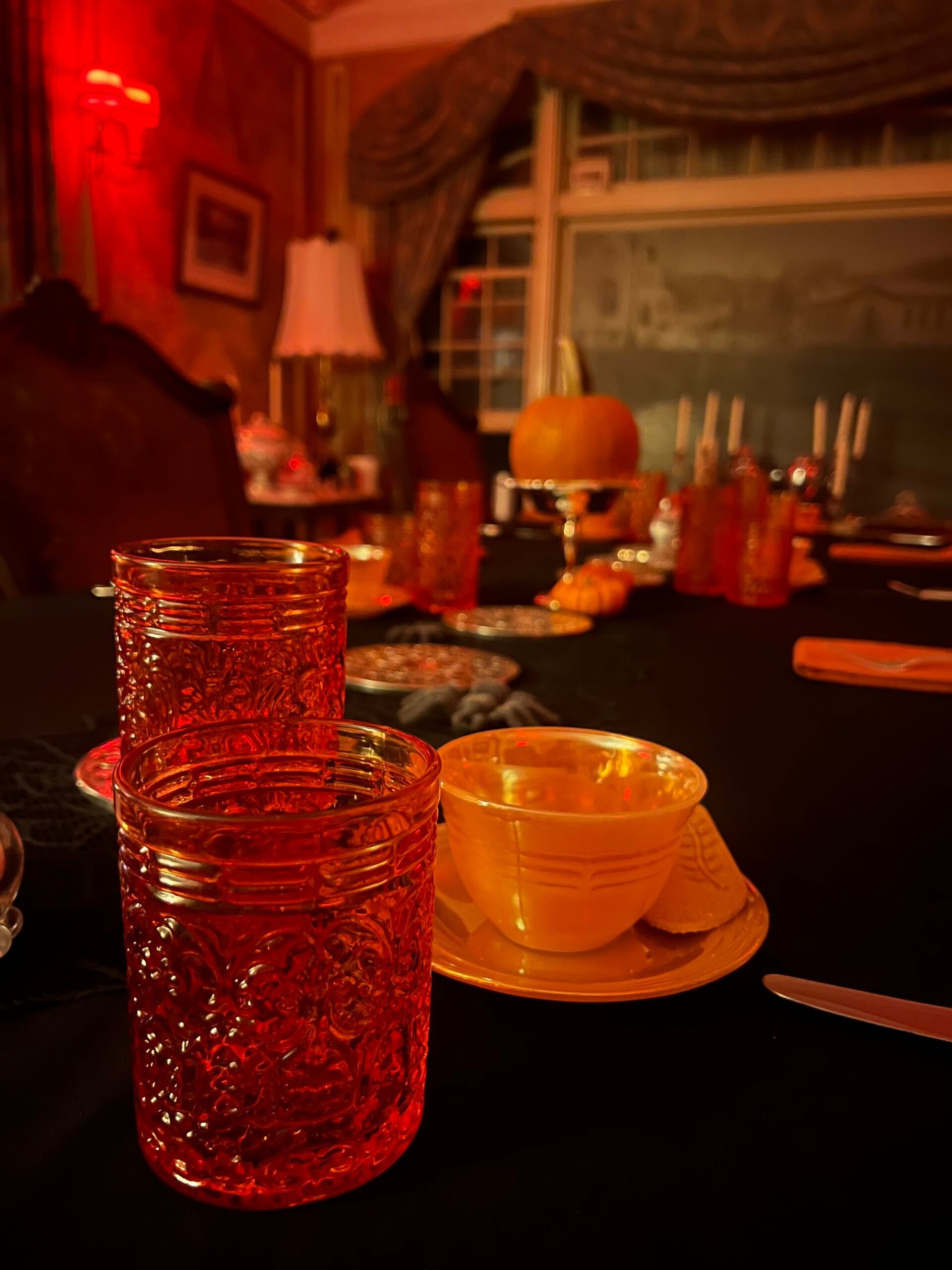 A stack of red glasses sits on a table