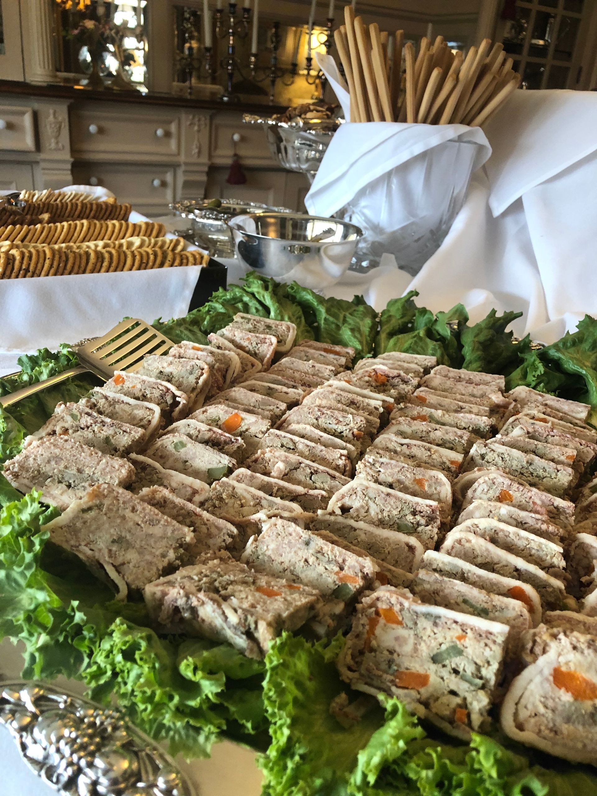 A tray of food is sitting on top of a table with lettuce.