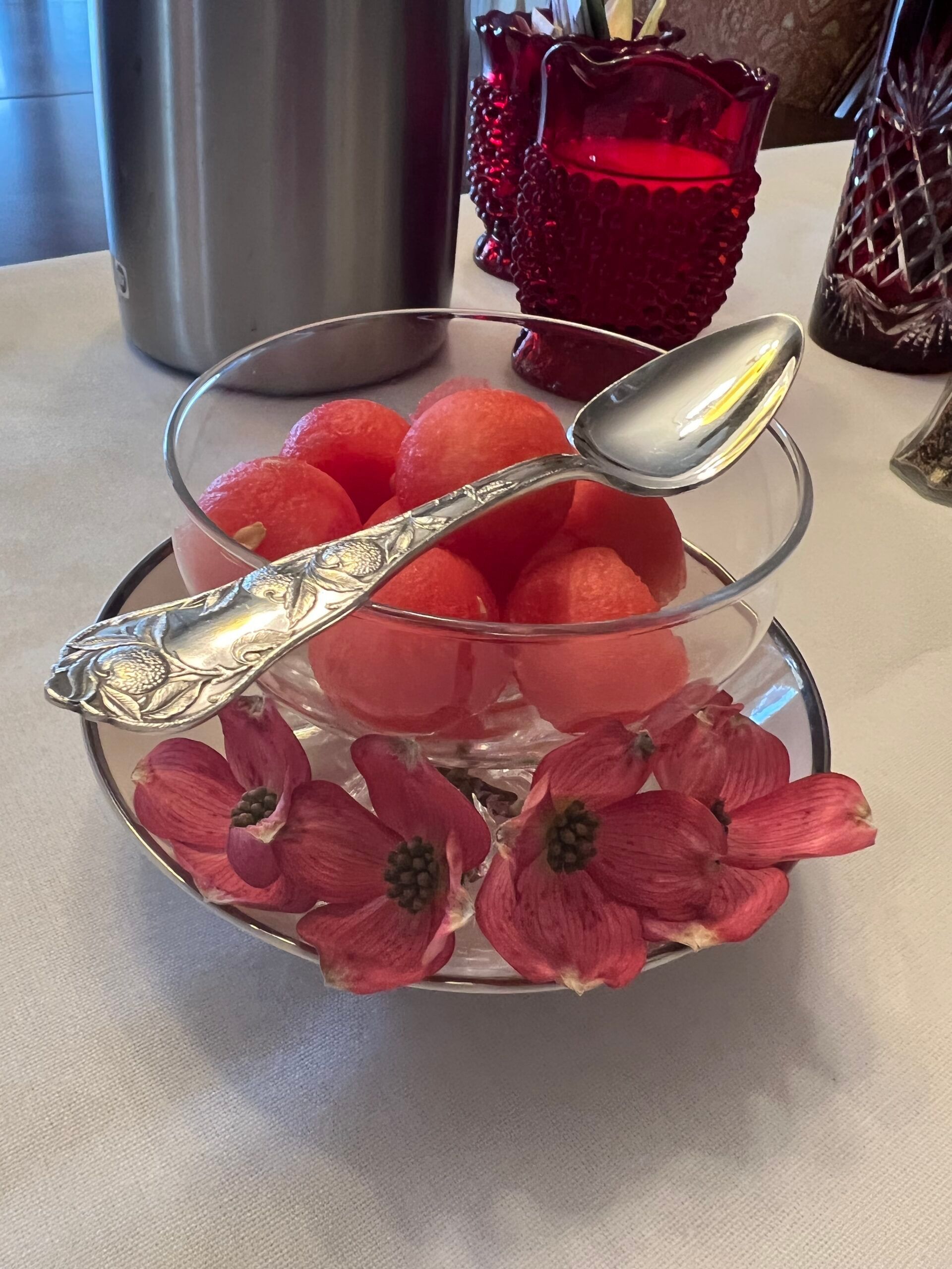 A bowl of watermelon with a spoon in it