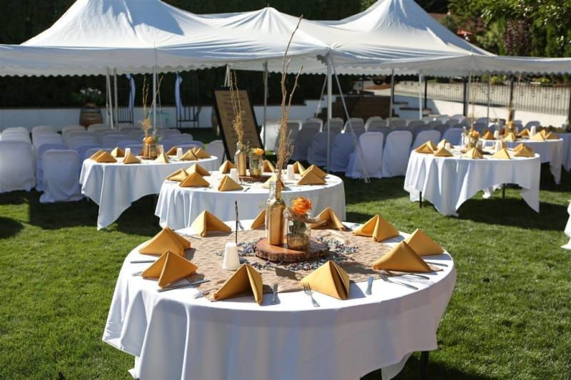 A bunch of tables set up for a wedding reception