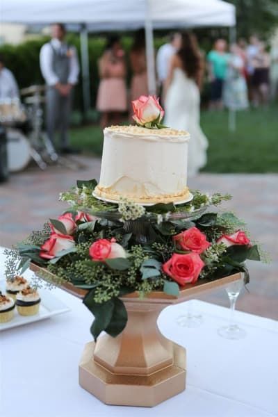 A wedding cake with roses on top of it