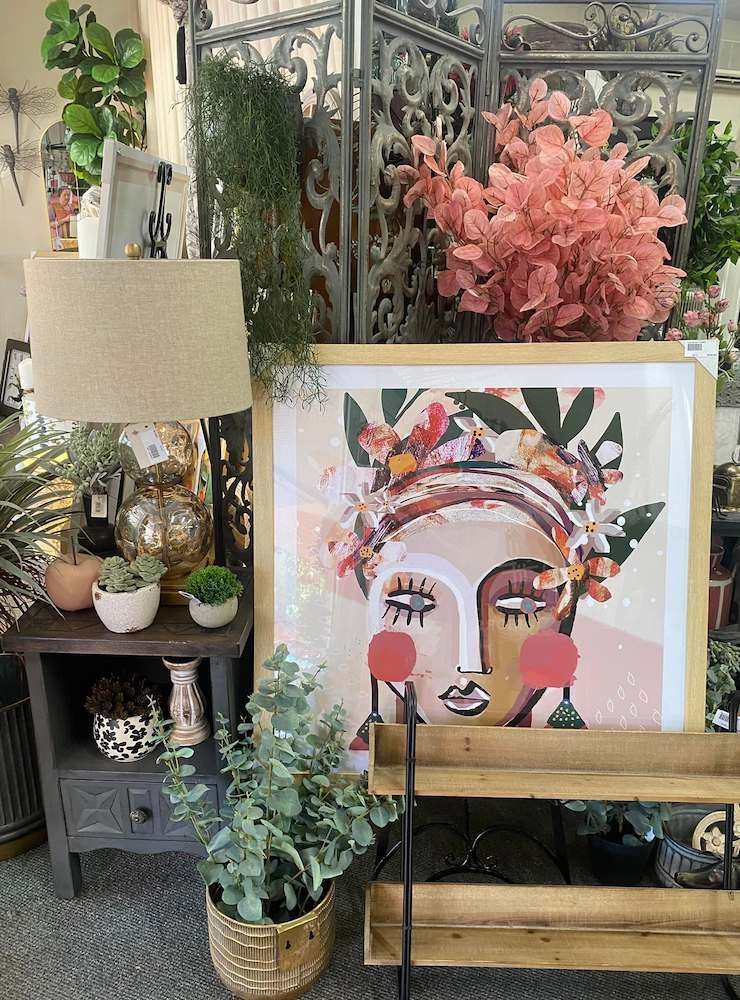 A Painting of a Woman's Face is Sitting on a Wooden Easel — Tamworth Interiors in Gunnedah, NSW