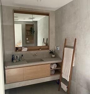 A bathroom with a sink , mirror and towel rack.