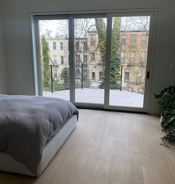 A bedroom with a bed and a sliding glass door