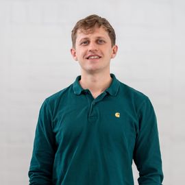 A man wearing a green carhartt polo shirt