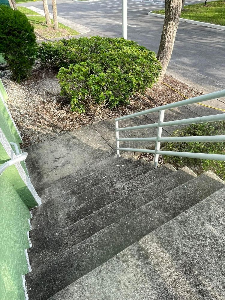 A set of stairs leading up to a building with a railing.