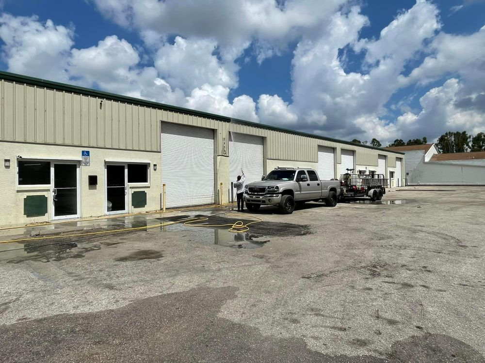 Two trucks are parked in front of a building.