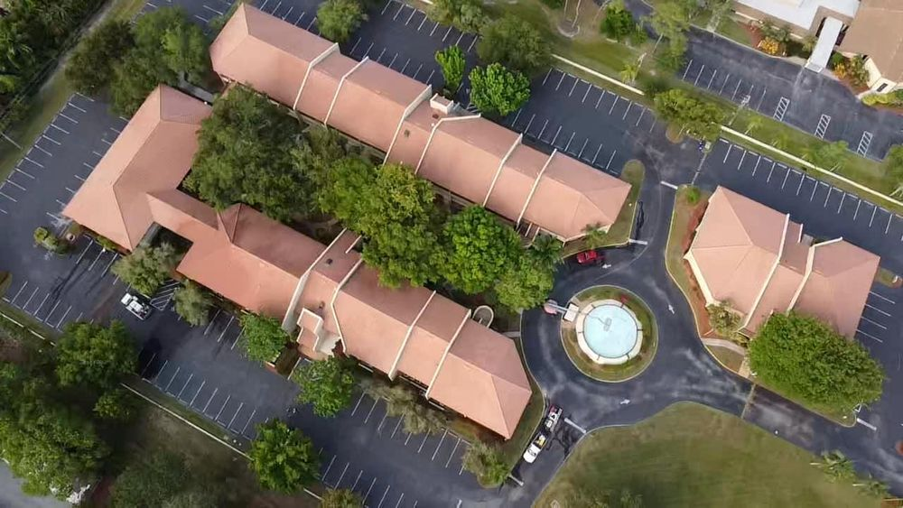 An aerial view of a building with a fountain in the middle of it