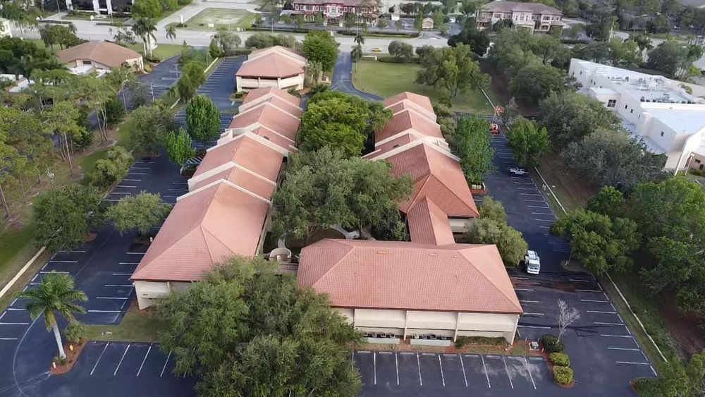 An aerial view of a building with a parking lot in front of it