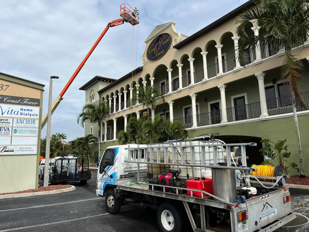A truck is parked in front of a large building.