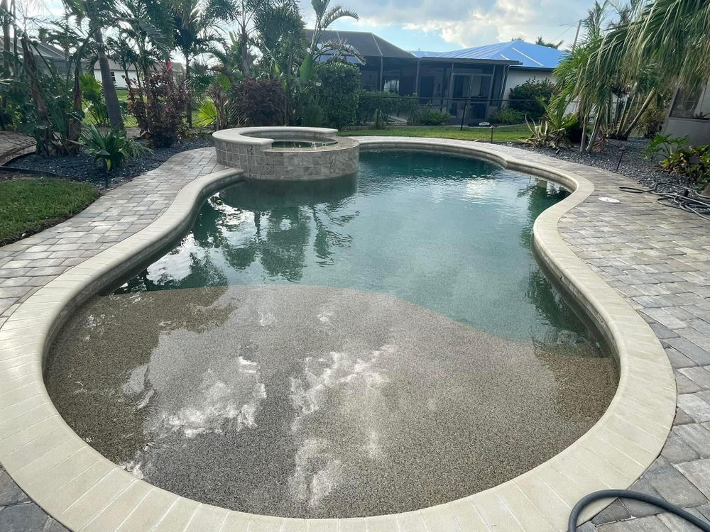A large swimming pool with a hot tub in the middle