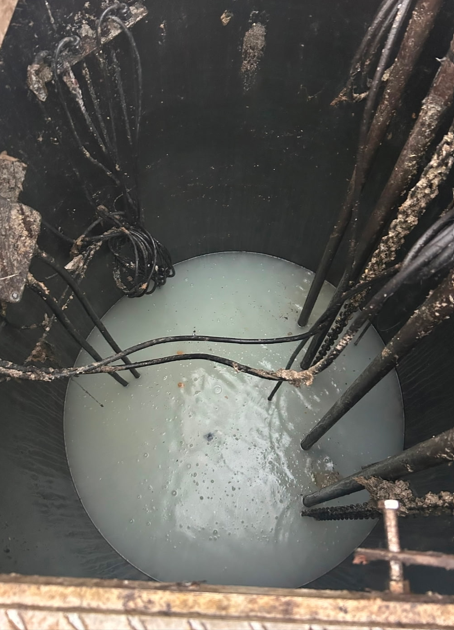 Green septic tank installation beside a house on a grassy lawn. Green septic tank installation beside a house on a grassy lawn.